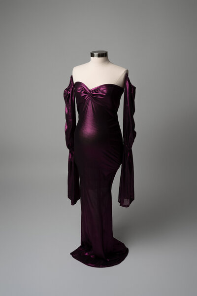 Red maternity gown with tulle overlay and bold shoulder detail