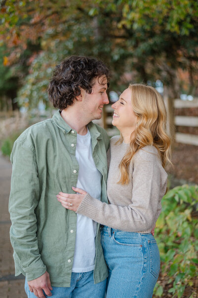 Engaged couple hold one another by the lake in the North Georgia Mountains