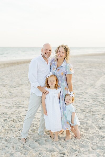 family laughing on beach at Emerald Isle with toddlers for family photos