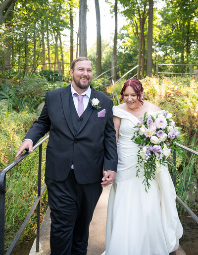 grooms holds brides face amongst flowers