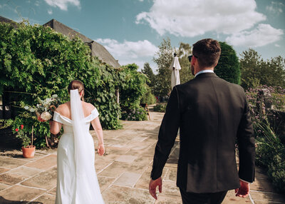 Bride and groom walking out of Holy Trinity Cambridge after having just got married