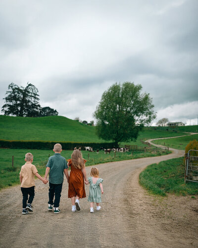 baby girl in a floral milk bath looking into camera