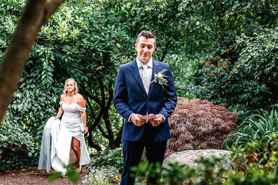 Bride and groom doing a first look in the secret garden at the gardens at uncanoonuc mountain by NH Wedding Photographer Lisa Smith Photography