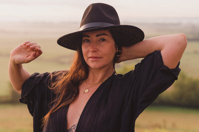 Miriam in black outfit and hat