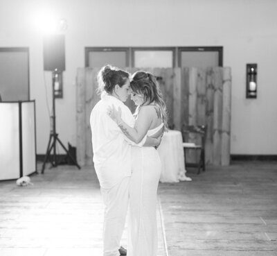 Bride and bride sharing their first dance during a romantic wedding reception, photographed by Nashville wedding photographer Diana Marie.