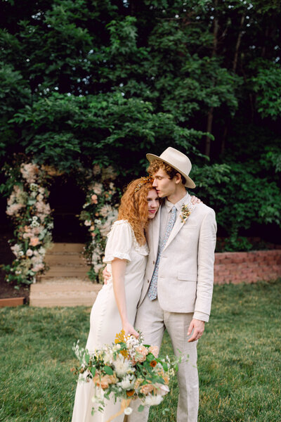 Peyton Curry and Jon share a heartfelt embrace during their intimate backyard wedding portraits in Richmond, Virginia. Captured by a Virginia film wedding photographer, this candid moment reflects the beauty of documentary-style wedding photography.