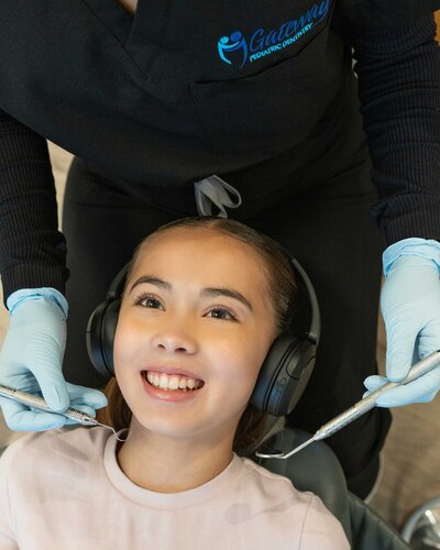 Smiling child showing off clean teeth after a successful dental check-up.