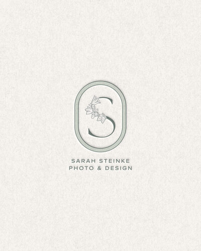 Elegant embossed logo for Sarah Steinke Photo & Design, featuring a refined monogram with botanical details on a textured neutral background