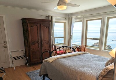 Bedroom featuring ocean view and large wood cabinet