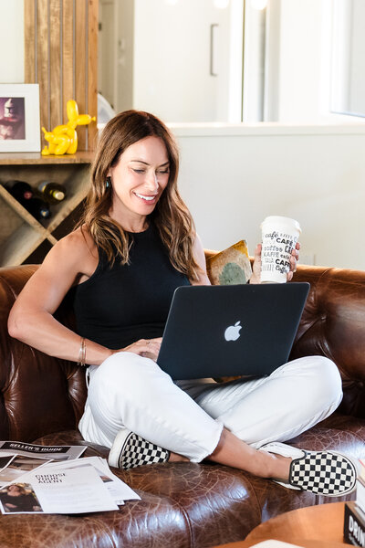 Business Coach on phone, and holding a coffee mug
