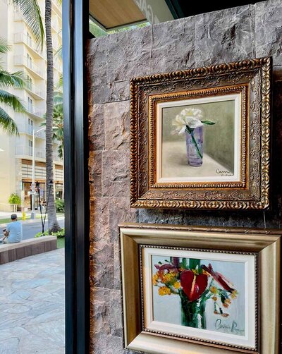 Two of artist Cam Rose's oil paintings of flowers hanging in Park West Gallery Honolulu