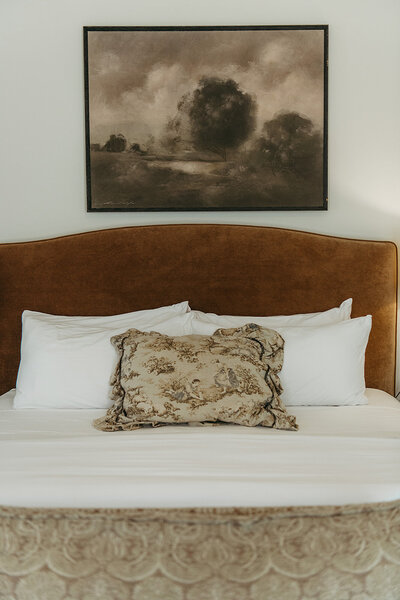 The Frio Suite King Bed has a plush caramel velvet headboard and the Inn's signature crisp white bedding.