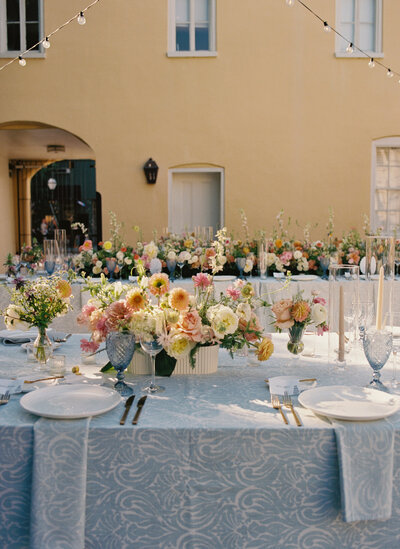 wedding tablescape filled with colorful pastel flowers and blue stradley davidson linens in charleston sc.