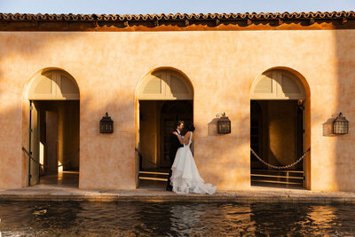 bride and groom embrace at wedding venue in arizona