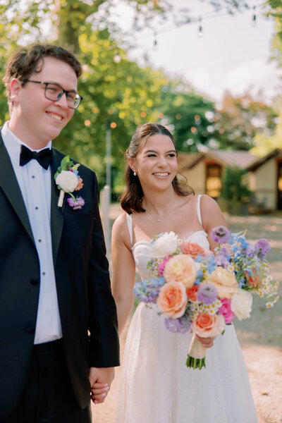 A couple holds hands on their wedding day.