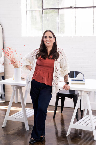 Stephanie, Founder of BCWise Consulting, standing at her desk 