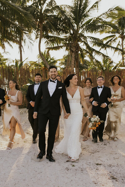 wedding party walk towards camera