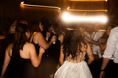 Bride dancing with guests at reception