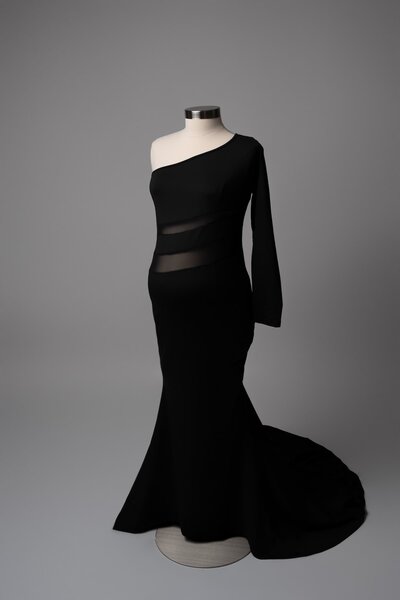 One-shoulder black dress with subtle mesh waist accent on mannequin