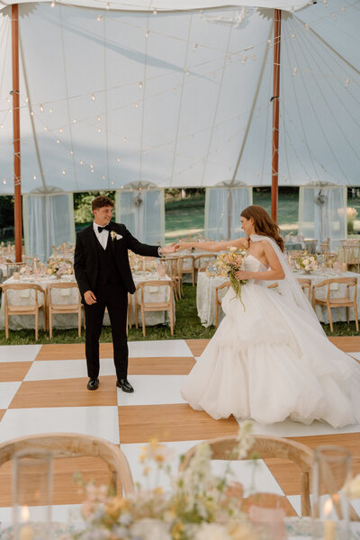 bride and groom dancing. under a sail cloth tent reception designed by wedding planners in Cleveland Ohio, Sirpilla Soirees