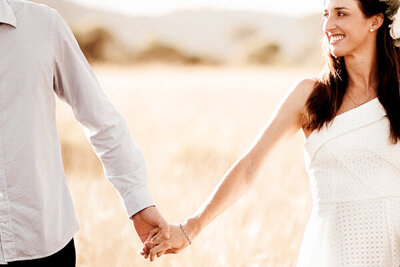 Engagement couple holding hands while walking