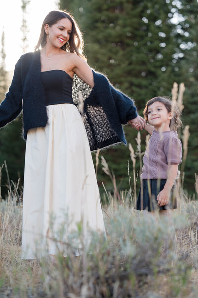 Mom dancing with her daughter in the golden hour light in Logan, Utah