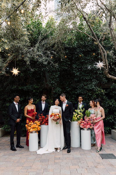 Bride and Groom with bridal party at Redbird laughing