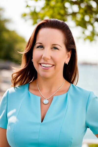 Theresa Salonis smiling outdoors, licensed EMDR trauma therapist specializing in birth and emotional trauma