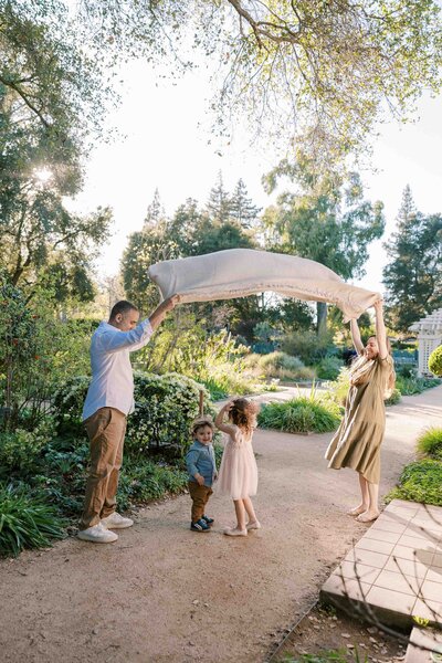 parents playing peekaboo with children