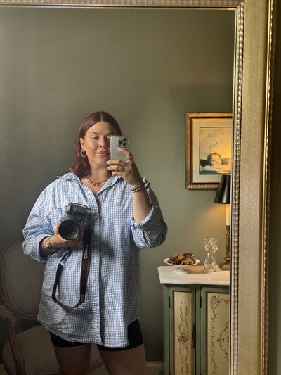 Mirror selfie of a stylish female interiors photographer in a hotel