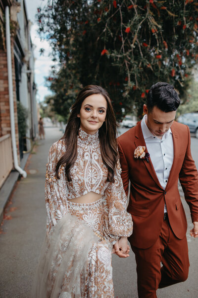 modern boho bride and her groom walking the inner city streets of melbourne