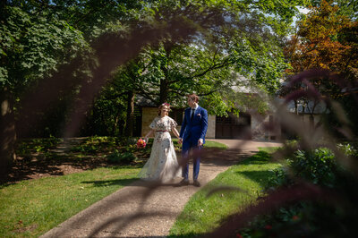 Bride and groom go for walk at The Grove Redfield Estate in Glenview, IL