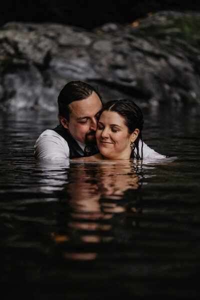 Adventure elopement playing in water at Spruce Flats Falls in the Great Smoky Mountain National Park