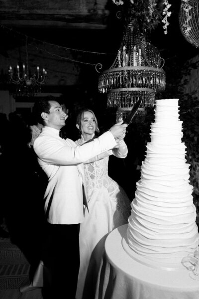 Bride and groom wedding cake cutting