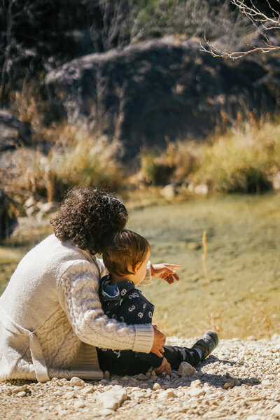 Woman and boy looking out at a creek