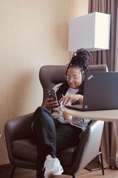 Alesia Hendley drinking coffee and looking at her phone