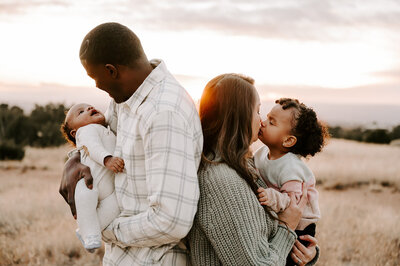 man and woman holding baby