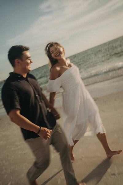 relaxed couple laughing on beach celebrating love