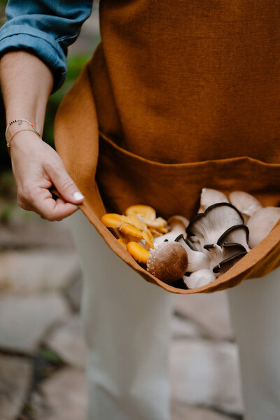 Sam holding mushrooms in her apron
