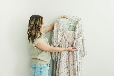 woman holding dresses for maternity newborn photos greenville nc