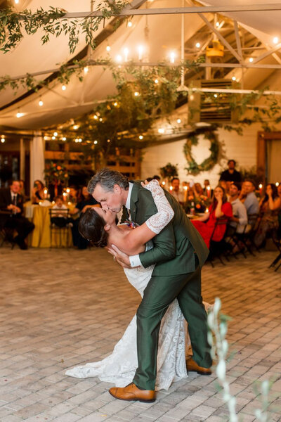 Couples deep kiss after their first wedding dance