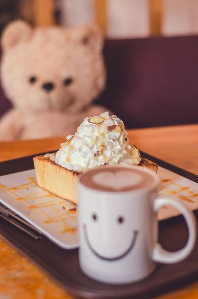Soft-seated lounge area at Petit Play Café with pillows and warm lighting