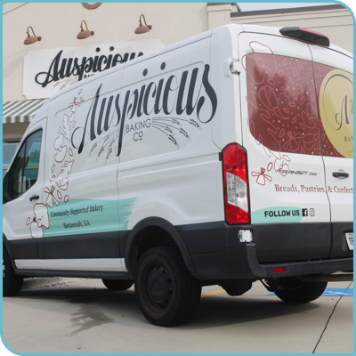 Auspicious Baking Co's delivery van with branded graphics on the side and back