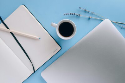Coffee and notebook on desk
