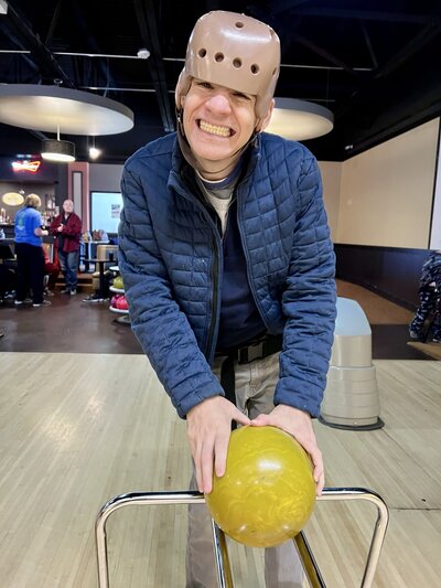 Image of solid rock friend smiling at bowling alley.