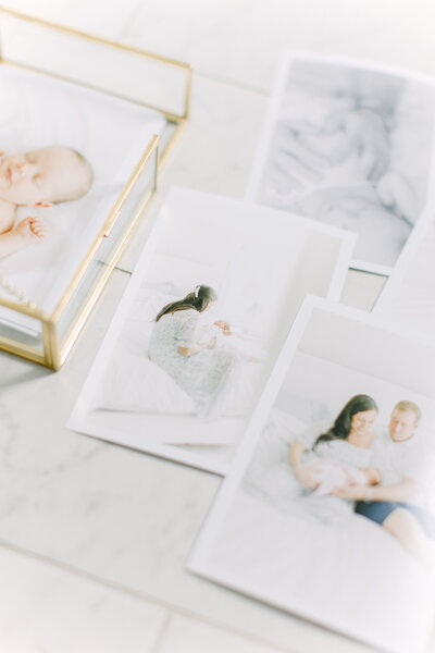 A photo taken of some sample printed photos from a newborn session