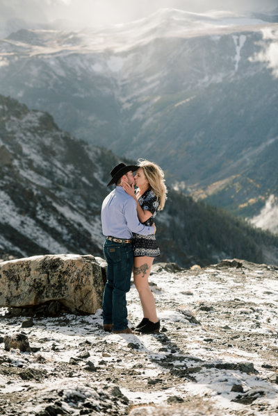 engaged couple in front of mountains