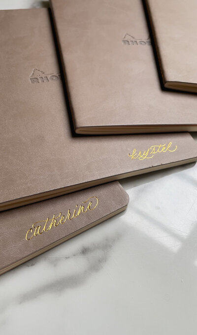 Brown leather notebooks with custom gold foil calligraphy