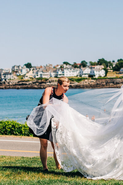 Boston wedding photographer headshot with a pug on Duxbury beach