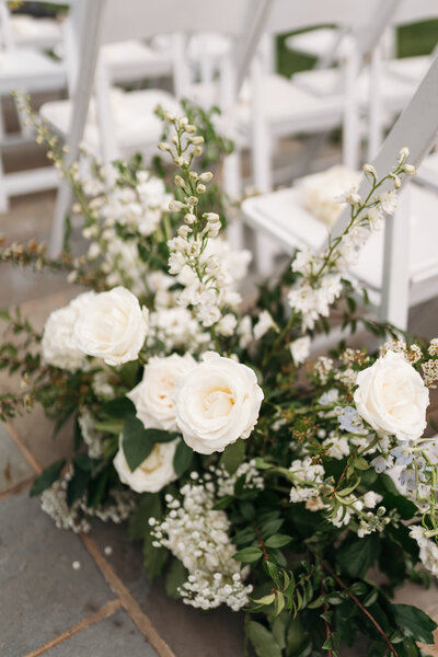 Close-up of a beautifully arranged wedding bouquet with roses and greenery